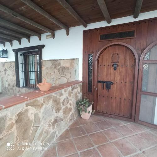 a front door of a house with a stone wall at Villa Calamaco in Los Gallardos