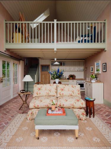 a living room with a couch and a balcony at 1-bed luxury seafront cabin in heart of Newlyn, Mousehole in Newlyn
