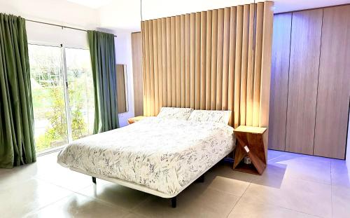 a bedroom with a bed and a large window at Palm Garden Valencia in Bétera