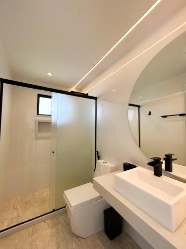 a bathroom with a sink and a toilet at La bardot boutique Pousada in Búzios