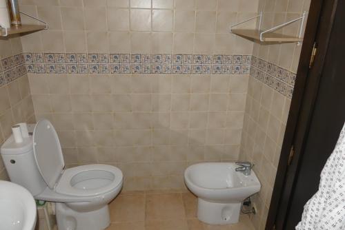 a bathroom with a toilet and a sink at RESIDENCE AL ANDALUS AP4 SAIDIA in Saidia 