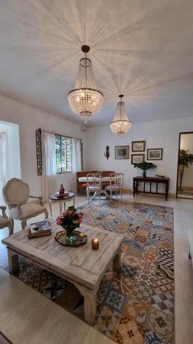 a living room with a wooden table and a living room at Leclerc Hotel Boutique Cali Granada in Cali