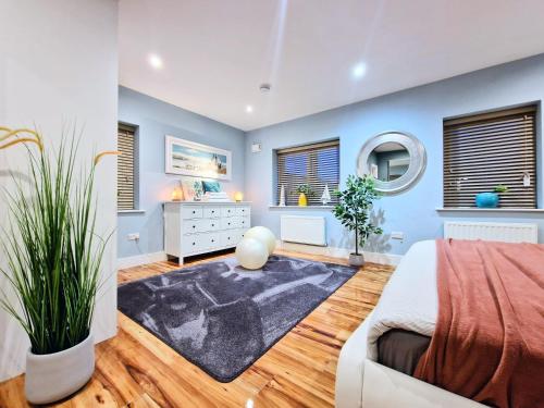 a bedroom with a bed and a dresser and windows at Master bedroom with ensuite in Lucan