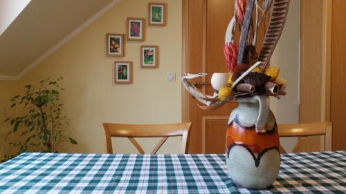 a stuffed animal is sitting at a table at Vadászkürt Panzió in Sopron