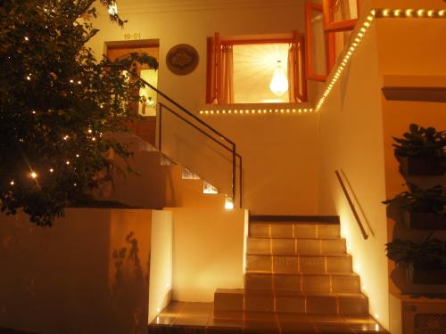 a staircase with lights on it with a christmas tree at Leclerc Hotel Boutique Cali Granada in Cali