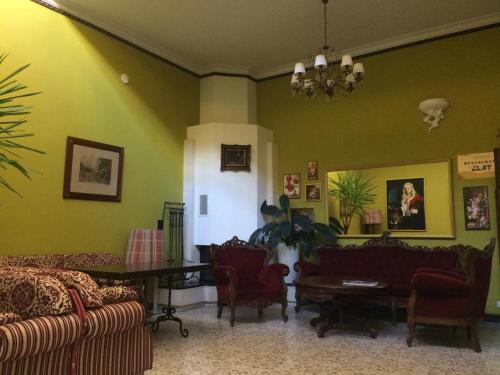 a living room with green walls and couches and a table at Vila Elat in Chişinău