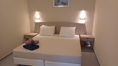 a small bedroom with a bed and two night stands at Villa Kavourakia in Kolios