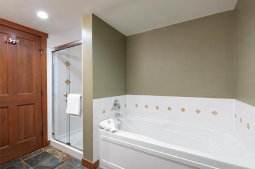 a bathroom with a large tub and a shower at Horstman House by Whistler Premier in Whistler