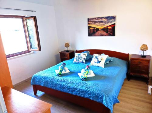 a bedroom with a bed with two toy cars on it at Villa Mali Raj in Zaton