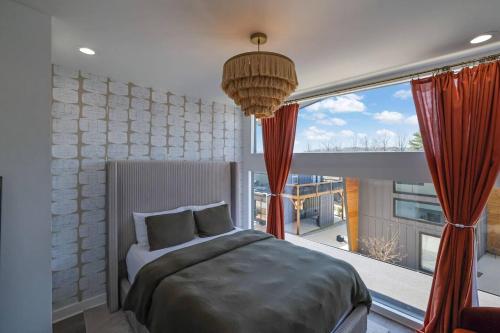 a bedroom with a bed and a large window at The Business Bungalow-5 Mins From Airport in Atlanta