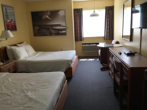 Ένα ή περισσότερα κρεβάτια σε δωμάτιο στο Annapolis Royal Inn & Suites