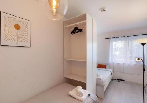 a white room with a bed and a window at Apartment Zola in Frankenthal