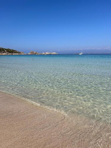 a body of water with a sandy beach at residenza del mare 80MQ 150MT da rena bianca in Santa Teresa Gallura