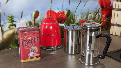 a table with three coffee makers and a can on it at Ferienwohnung im Kontor Penzlin in Penzlin