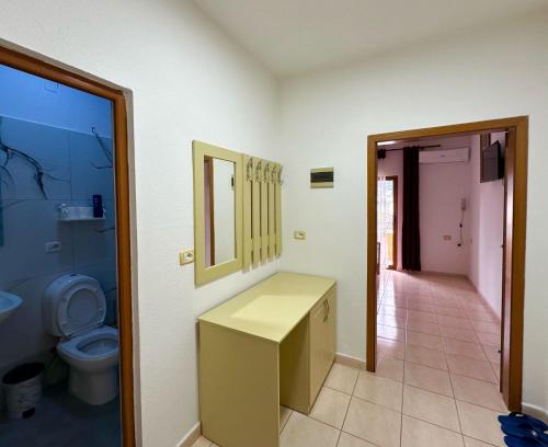 a bathroom with a sink and a toilet at Maria Guest House in Përmet