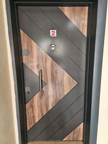 a black wooden door with a sign on it at The Titanic House Hotel in Pamukkale