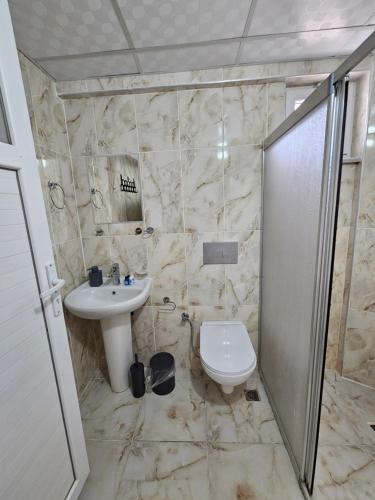 a bathroom with a sink and a toilet at The Titanic House Hotel in Pamukkale