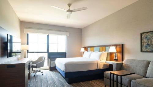 a hotel room with a bed and a couch at Hampton Inn & Suites Maui North Shore in Kahului