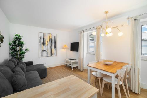 a living room with a couch and a table at Modern Lisbon Apartments by Soulplaces in Lisbon