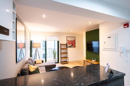 a kitchen and living room with a couch and a table at Bohemian Barranco Apartments by Geko in Lima
