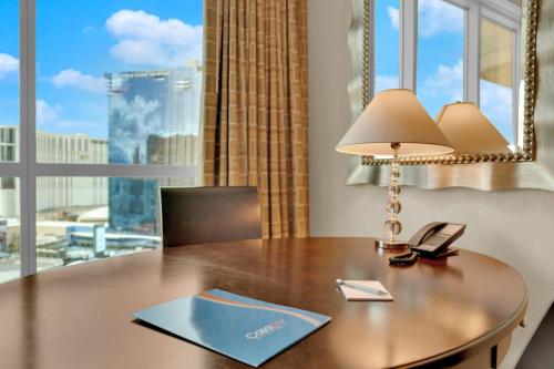 a desk with a lamp and a book on it at Mirai MGM Signature in Las Vegas