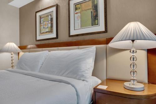 a bedroom with a bed with two lamps on a table at Mirai MGM Signature in Las Vegas