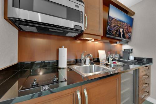 a kitchen with a sink and a microwave at Aurora Haven MGM in Las Vegas