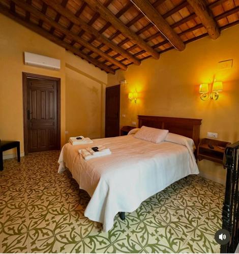 a bedroom with a large bed in a room at Casa Rural La Plazuela in Cazalla de la Sierra