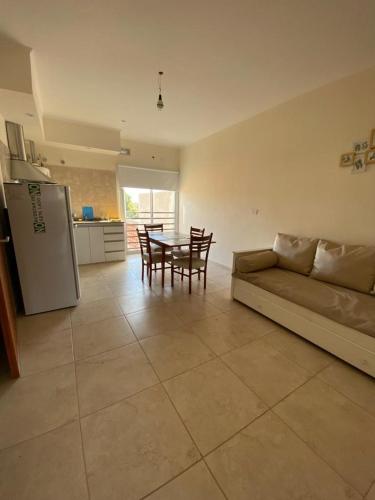 a living room with a couch and a table and a kitchen at Espacio Millán in Concepción del Uruguay
