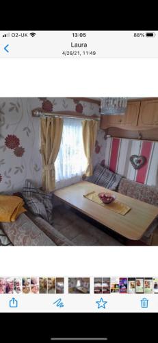 a picture of a bedroom with a table in it at Summerlands caravan park, p29 in Skegness