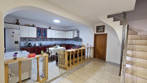 a large kitchen with a staircase in a house at Maria Guest House in Përmet