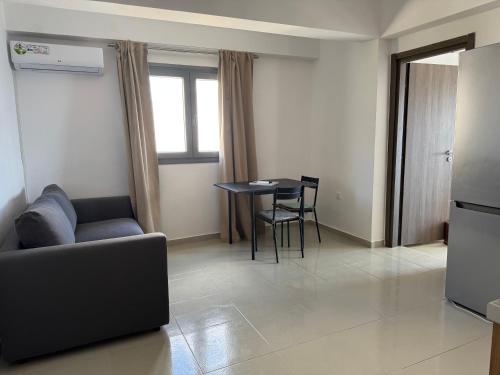 a living room with a couch and a table at Previllage Red Apartments 7-8 in Kos Town