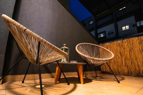 two chairs and a table in a room at Angelina city LUX apartment with garage in Belgrade
