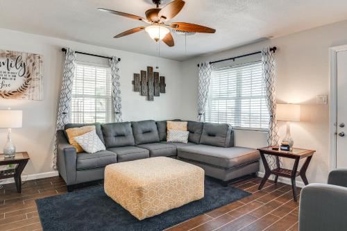 a living room with a couch and a table at Walk to Town Home with Yard in Brenham! in Brenham