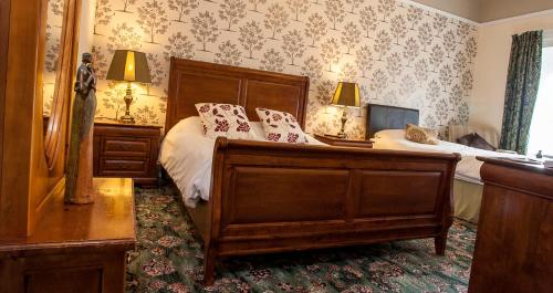 a bedroom with a large bed with white sheets at Bank Guest House in Wick