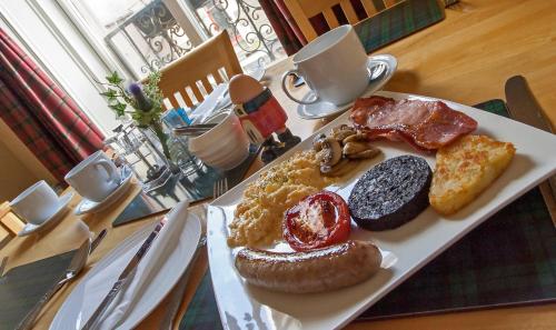 a plate of breakfast foods on a table at Bank Guest House in Wick