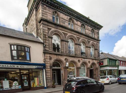 a black car parked in front of a building at Bank Guest House in Wick