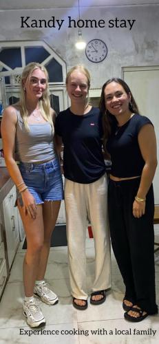 three women standing next to each other in a room at Kandy Home stay in Katugastota