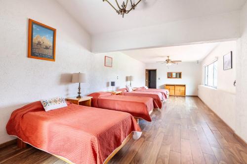 a group of four beds in a room at Paradise Villa in Cocoyoc in Cocoyoc