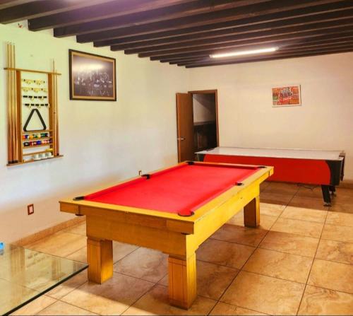 a pool table in a room with a red top at Paradise Villa in Cocoyoc in Cocoyoc