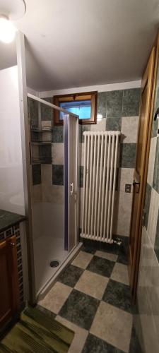 a bathroom with a walk in shower next to a glass door at La Sosta1-2 in Arliod