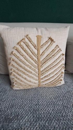 a pillow shaped like a book sitting on a bed at L'airial de Laure in Ondres