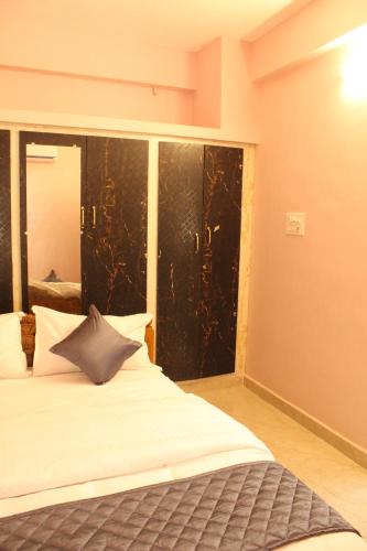 a bedroom with a bed and a large window at Fort Square Apartments - 101 in Vellore