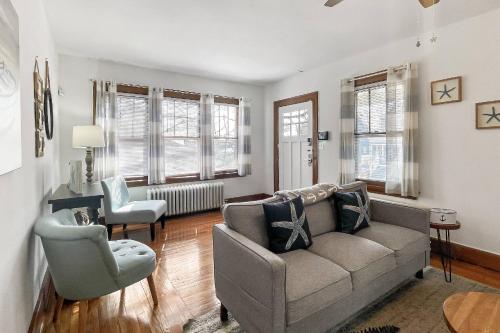 a living room with a couch and a chair at Grove Place Beach West Haven in West Haven