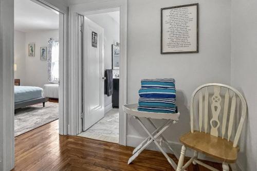 a room with a chair and a mirror at Grove Place Beach West Haven in West Haven