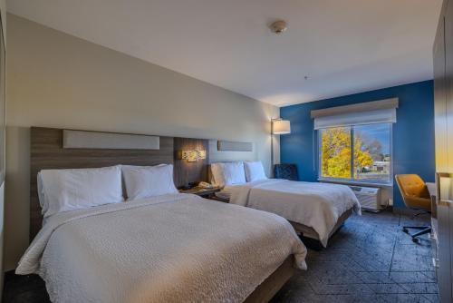 a hotel room with two beds and a window at Holiday Inn Express & Suites Denver North - Thornton by IHG in Thornton