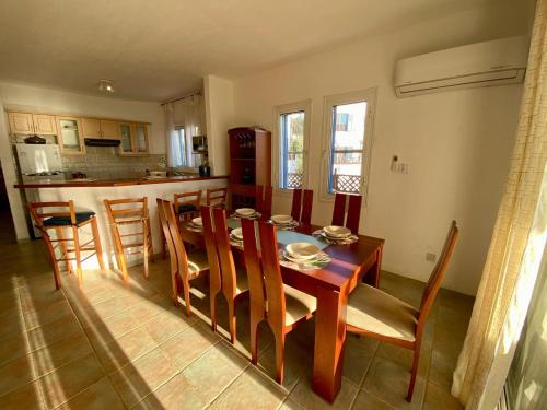 a kitchen and dining room with a table and chairs at Sea Front Villa Ekaterina in Paphos City