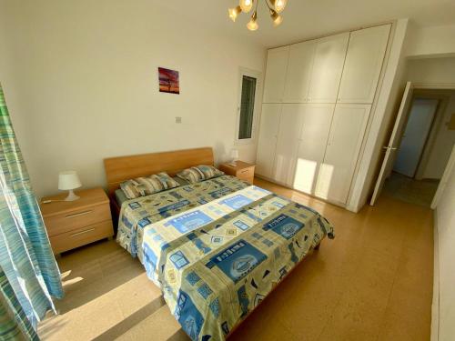 a bedroom with a bed and a dresser and a bed sidx sidx sidx sidx at Sea Front Villa Ekaterina in Paphos City