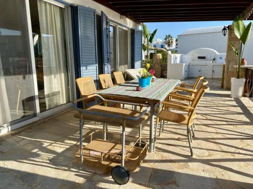 a table and chairs sitting on a patio at Sea Front Villa Ekaterina in Paphos City