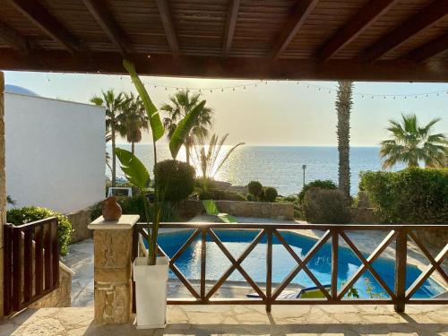 a resort with a swimming pool and the ocean at Sea Front Villa Ekaterina in Paphos City